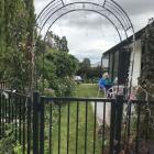 A welcoming archway which frames Sherryn Bryan sitting in her garden. PHOTOS: GILLIAN VINE