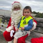 Pleased to meet you ... Lincoln Evans, 2, meets Santa for the very first time outside the St...