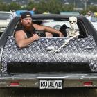 Axl Tilden has company in his Halloween-themed hearse — a 1975 Plymouth Fury — at the 35th Great...