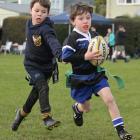 Elliott Grace, 6, of Kaikorai, gets away from Dunedin’s Abraham Thompson, 6.