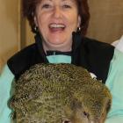 Conservation Minister Maggie Barry holds a kakapo chick at the Department of Conservation chick...