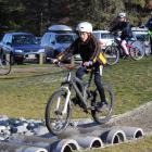 Finn Thomson (11), of Mount Aspiring College in Wanaka, steadies himself over obstacles at the...