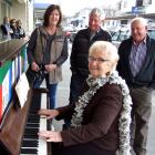 Alexandra musician Valerie Anderson plays for shoppers, watched by (from left) Yvonne Tohill, of...