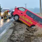 Outram volunteer firefighters clear the Henley - Berwick Rd after a courier van left the road...