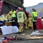 Emergency services tend to one of the two people involved in a motor vehicle accident on Dunedin...