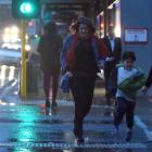 Pedestrians run across Stuart St as what started as a warm and fine day in Dunedin gave way to...