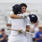 England's Alastair Cook celebrates his century with Joe Root. Photo by Reuters