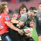 Kieran Read of the Crusaders tackled by Andries Coetzee of the Lions during the Super Rugby match...