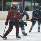 Shaun Harrison, of the Dunedin Thunder, looks to beat Ciaran Long, of the Canterbury Red Devils,...