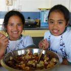 10-year-olds Renae Wanahi (left) and and Shanaia Hauraki make a purini huarakau (fruit salad) for...