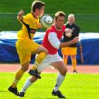 Otago Youth midfielder Curtis Day shows tight control under pressure from Caversham's Aaron...