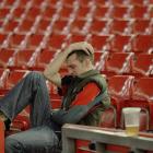 A Welsh rugby fan is disconsolate after watching the game on big screens at the Millenium Stadium...