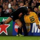 Richard Kahui dumps Quade Cooper on his back. REUTERS/Mike Hutchings