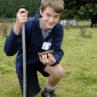Taieri College pupil Alex Keith (14) takes soil samples as part of the science section of the...