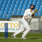 Scott potential . . . Otago batsman Bradley Scott watches an edge sail to safety on the third day...