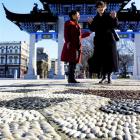 Prime Minister Helen Clark is escorted by Dunedin Chinese garden manager Siew Gek Sim on a tour...