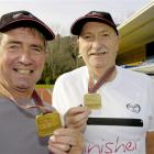 Dunedin marathon runners Ron Esplin (left) and Gavin Craw hold the centennial medals won for...