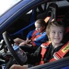 Hamish Bedwell (11) (right), and brother Connor (6), of Dunedin, enjoy sitting in a car formerly...