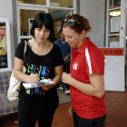 Sasha Ward-Faint (18) (left) fills out an enrolment form assisted by Lucy McAuliffe (21) from...