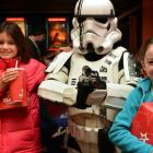 Ngaio (left) and Kiriana Davidson-Duell with Star Wars storm trooper Warren Goodwin during the Star Wars Marathon at the Rialto in Dunedin yesterday.  Photo by Peter McIntosh.