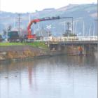 Full steam ahead: Dunedin train track work, such as the recent re-railing of the Leith Bridge...