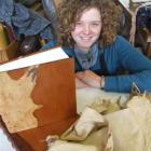 Jenny Lacey shows off the book she created using possum skin and totara wood. Photo by Sally Rae.