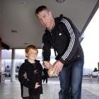 All Blacks lock Brad Thorn signs a ball for Cameron Gascoyne (7), at Dunedin International...