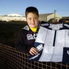 Alex Timmings (9) at the site of the Awatea St stadium with his petition in support of the...
