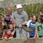 Checking out smolt at the Dunedin Community Salmon Hatchery in Sawyers Bay yesterday are Sawyers...