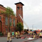 Firefighters work in the fireground at Invercargill's First Presbyterian Church yesterday.