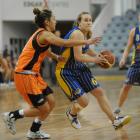 Janet Main, of the Otago Goldrush, makes her way around Harbour Breeze player Chelsea Terei...