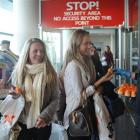 Jetstar promotions staff, Alyson Dunbar (21, right)  welcomes passengers from Auckland,  Danielle...