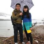 Lei Huang and Xlaolu Du, of China, did not mind the waterfront debris left by a swollen Lake...