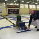 Maniototo Curling International Inc manager Bruce McCormick clears ice from the machine used to...