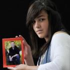 Melanoma awareness campaigner  Karli Adams (14)  holds a favourite photo of her father, Garth, ...