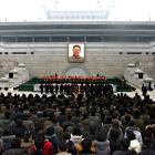 North Koreans lay flowers in front of a portrait of late leader Kim Jong Il in Pyongyang, North...