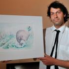 ''Oil on Canvas'' co-ordinator Ted Whitaker prepares to hang The Adventures of Sydney Penguin...