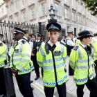 Police guard the entrance to Downing Street during a rally in central London against the proposed...