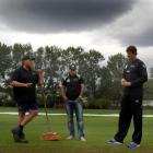 University Oval groundsman Tom Tamati (left) chats to Black Cap all-rounders Nathan McCullum ...