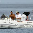 A 2004 AP file photo of Tiger Woods, left, driving a boat off the yacht "Privacy," anchored off...