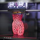 A 3-D printer creates a sculpture of a woman at the DMY International Design Festival at the...