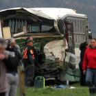 A badly damaged bus pictured at the scene of an accident involving a school bus and a logging...