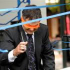 A blindfolded Dunedin Mayor Dave Cull cuts the ribbon to open the 2011 Dunedin Fringe Festival...