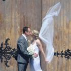 A breeze catches the veil of Alison Shanks' wedding dress as she kisses her husband Craig Palmer...
