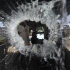 A bullet hole pierces the window of a small police station in the Del Castilho neighbourhood in...
