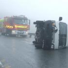 A  campervan  on its side blocks  a lane on the Crown Range Rd on Saturday. Photo by Christina...