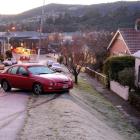 A car rests against a street light pole after skidding out of control in icy conditions on...