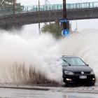 A car sprays pooled water at the intersection of Fryatt and Wharf Sts  in Dunedin yesterday....