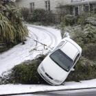 A car teeters on the side of the drive leading to St Mary's Church presbytery on Taieri Rd. Photo...
