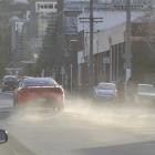 A car throws up a cloud of dust in Albany St, Dunedin, where airborne dirt and soil particles...